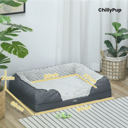 Dog bed with dimensions labelled, placed indoors with plants and a curtain in the background