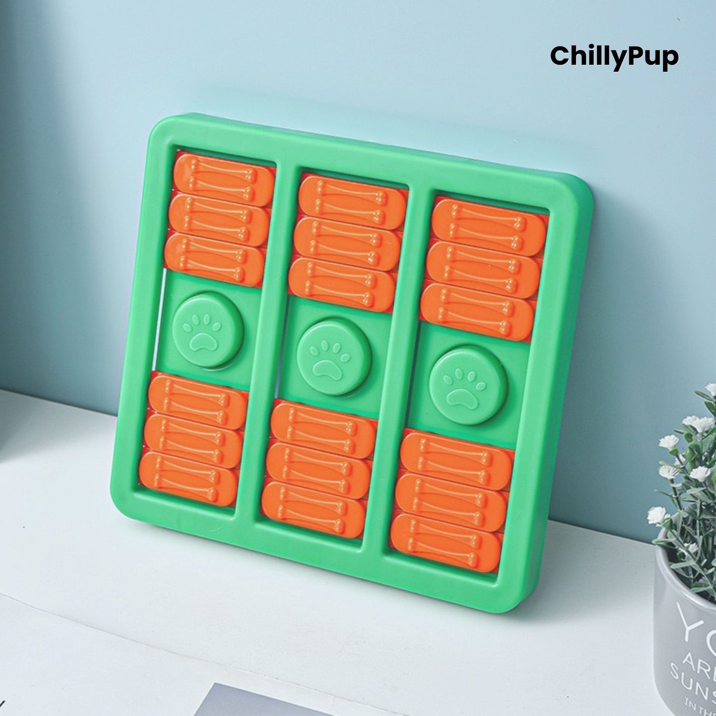 Green plastic pet toy with orange and green shapes on a white surface, branded 'ChillyPup'.