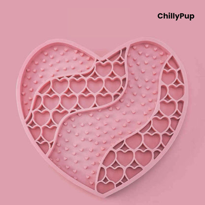 Heart-shaped purple dog lick mat with textured surface on a light gray background, branded 'ChillyPup'.