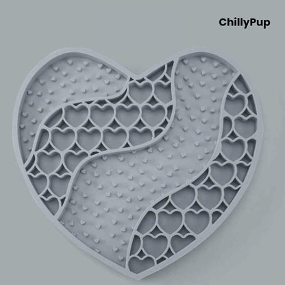 Heart-shaped purple dog lick mat with textured surface on a light gray background, branded 'ChillyPup'.