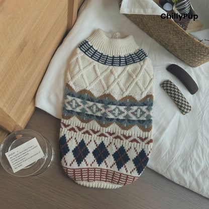 Knitted dog sweater with geometric pattern on a wooden surface, brand 'ChillyPup' visible.