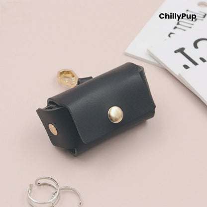 Black leather ring pouch with gold accents on a light pink background, featuring the brand 'ChillyPup'.